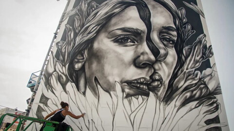An artist works on a mural at KAABOO 2017 at the Del Mar Racetrack and Fairgrounds in San Diego in 2017.