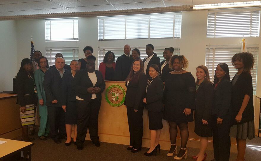 San Diego County Deputy Public Defender Geneviéve Jones-Wright (far right) poses in this undated photo with Lincoln High School students she helps support as a mock trial team coach.