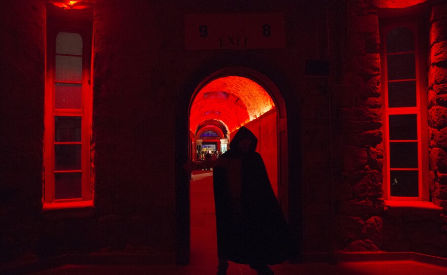 An actor looms in the prison's rotunda during the haunt. "Terror Behind The Walls" sets are constructed in a way where it does not damage the prison's structure and can quickly be removed.