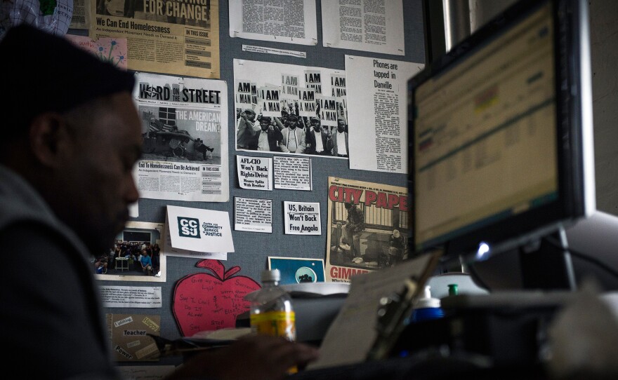Simmons works at his desk at the office for Word on the Street, Baltimore's newspaper for the homeless, covering issues of homelessness and poverty.