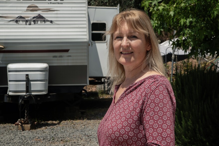 Karin Allison stands in front of the old FEMA trailer she and her family rent-to-own from Green Oaks Ranch Ministries, where she lives with her husband and three teenagers on June 10, 2024 in Vista, Calif.