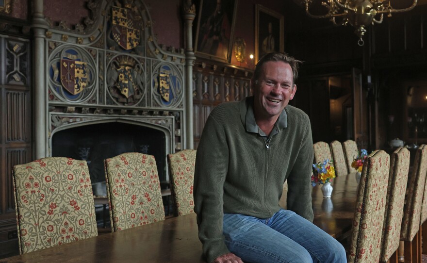 Aristocrat Charles Courtenay, 19th Earl of Devon, pictured alongside his family Coat of Arms.
