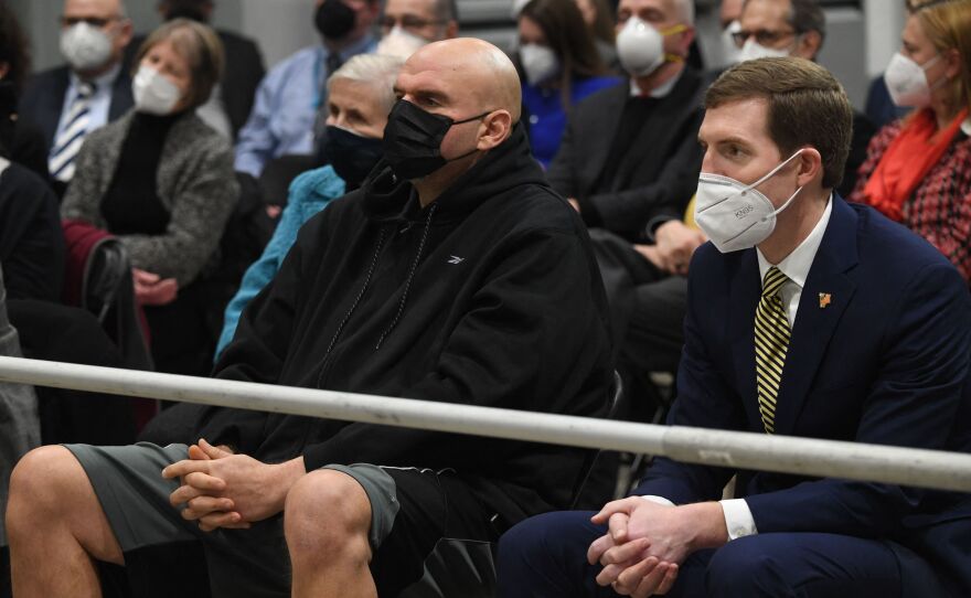 Pennsylvania Lt. Gov. John Fetterman, center, and his Democratic Senate primary rival Rep. Conor Lamb wait as President Biden prepares to speak about the economy in Pittsburgh on Jan. 28.