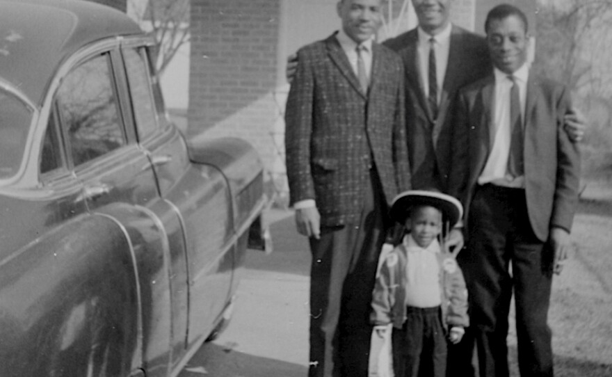 Medgar Evers embraces friends James Meredith (left) first black student to enroll in the University of Mississippi (with Evers' help), and iconic writer James Baldwin (right), who covered the civil rights movement for magazines like The New Yorker. Van Evers stands in front: "It's one of the very few photos I have of my Dad and me."