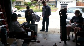 Members of the 501st Legion gather in Drew Hannah's garage to work on their stormtrooper armor.