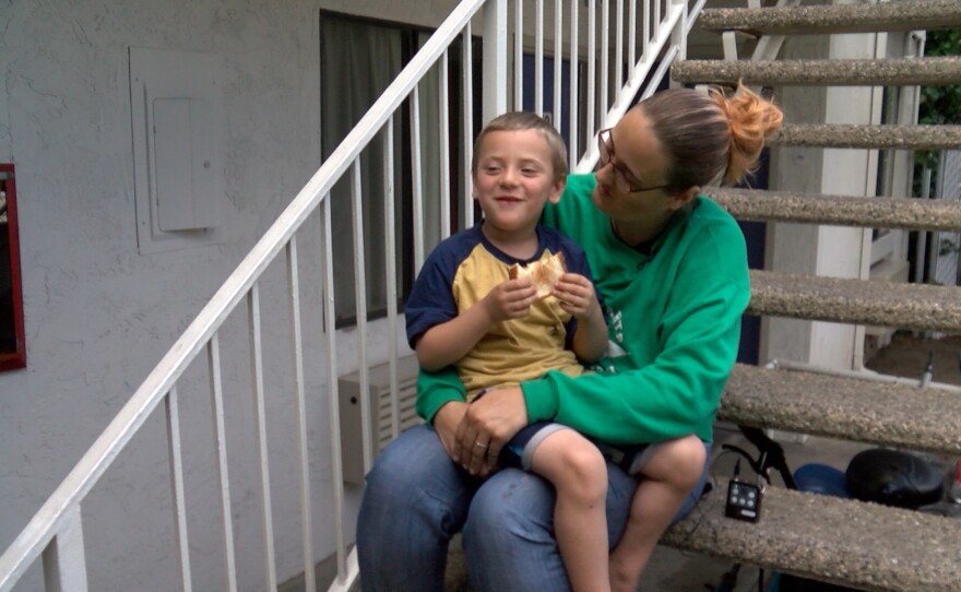 Desiree Young and her son sit on a staircase at the Carlsbad Village Inn where they are clients of the Oceanside Homeless Resource shelter. June 21, 2021. 