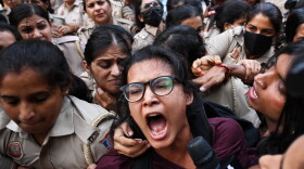 Prominent student leader Neha Bora, center, shouts slogans as she is detained by the police during a youth demonstration demanding the resignation of the country's election chief Gyanesh Kumar, in New Delhi, India, Friday, Oct. 16, 2026.