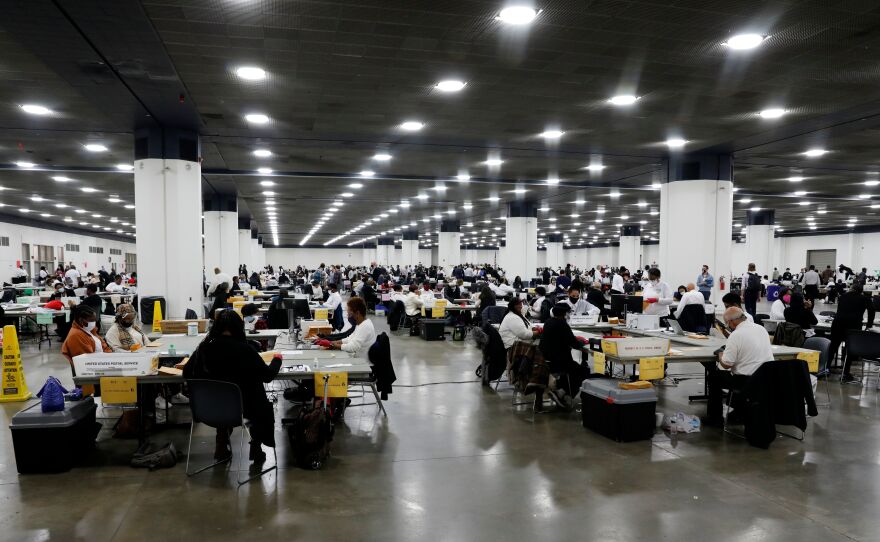 Detroit election workers count absentee ballots for the 2020 general election at TCF Center on Nov. 4. Election offices around the U.S. say they couldn't have carried out this year's challenging election without help from a nonprofit tied to Facebook CEO Mark Zuckerberg.