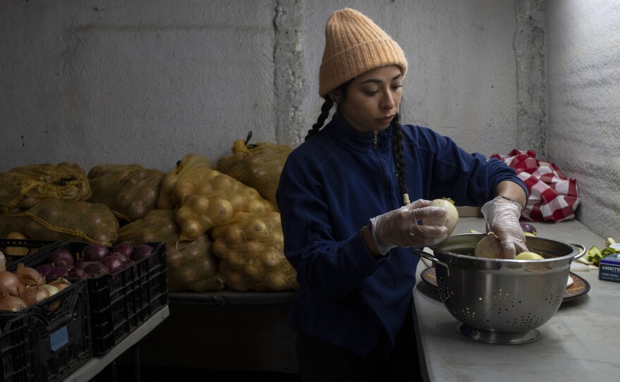 Jimena Cordero is farm manager at Ollin Farms and Mark Guttridge's daughter. She prepares veggies for an upcoming meeting to discuss Boulder County Sustainability.