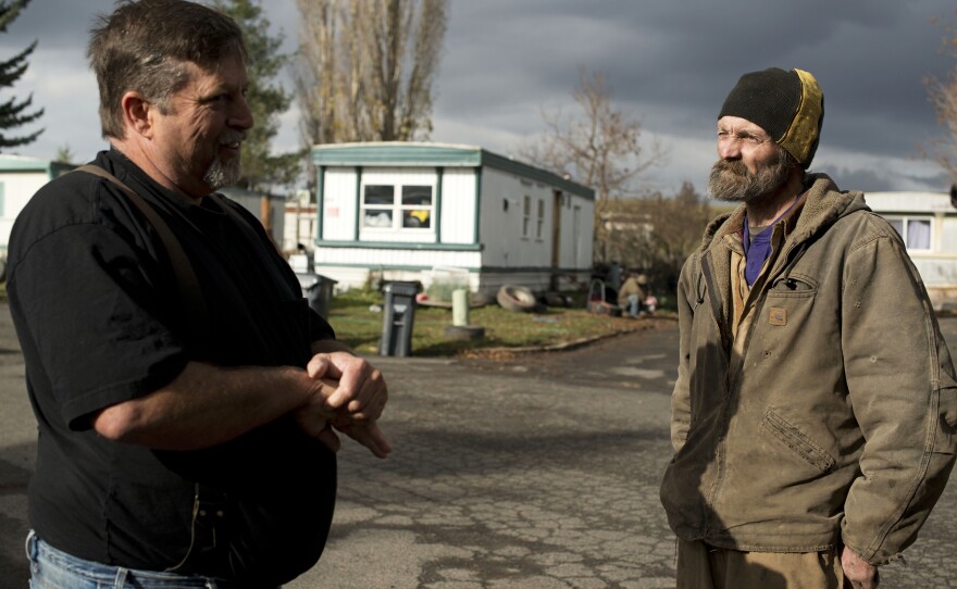 James Ware (left) speaks with fellow Syringa resident Reggie Thistlewait. Ware had been warning government officials for years that there were chronic problems in Syringa, but little had changed.