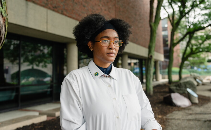 Netia McCray stands outside the Museum of Science, where she runs a STEM educational program for teens, in Boston, Mass. McCray has been suffering from long COVID since 2020.