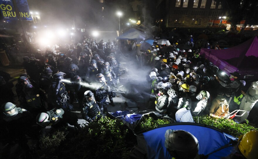 Police face off with pro-Palestinian students after dismantling part of the encampment barricade on the UCLA campus in Los Angeles early on May 2.