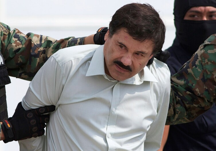 Joaquin "El Chapo" Guzman, head of Mexico’s Sinaloa Cartel, is escorted to a helicopter in Mexico City following his capture overnight in the beach resort town of Mazatlan, Feb. 22, 2014.
