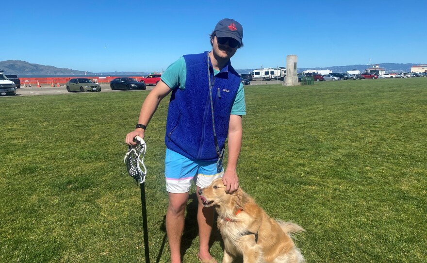Sam Runkle sports a blue Patagonia vest while out with his golden retriever in San Francisco's Marina neighborhood.
