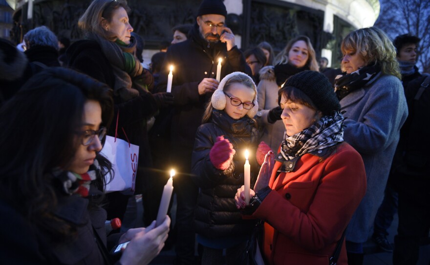 People light candles during a vigil at the Place de la Republique in Paris. French President Francois Hollande declared Thursday a day of mourning and asked the French to hold a minute of silence at noon.