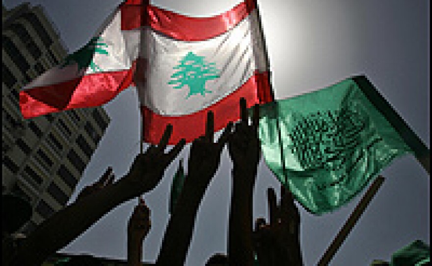 Palestinians in Gaza City hold up Lebanese and Hamas flags during a protest against the ongoing Israeli incursion into southern Lebanon.