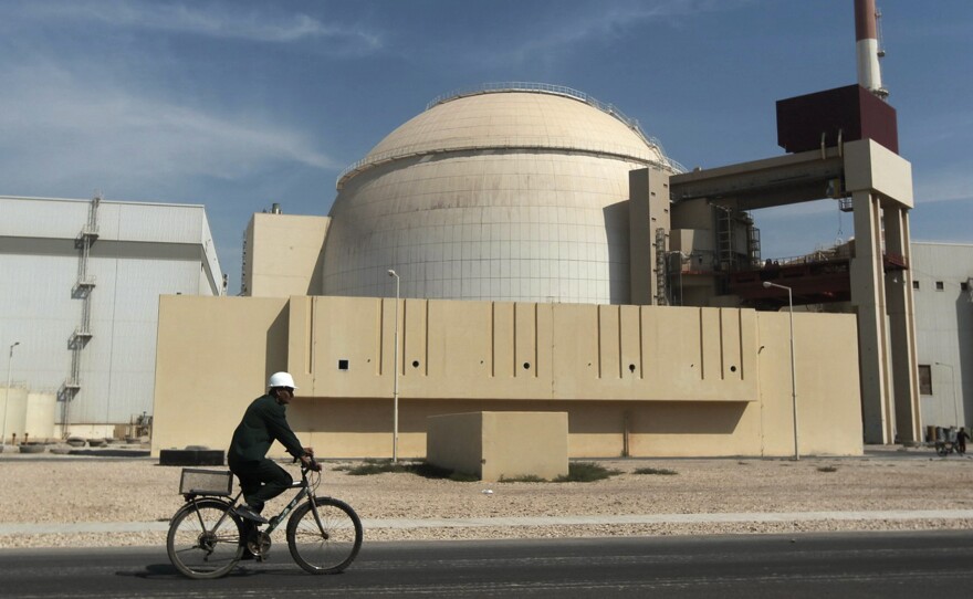 A worker rides a bicycle in front of the reactor building of the Bushehr nuclear power plant, just outside the southern city of Bushehr, Iran, in a 2010 photo.