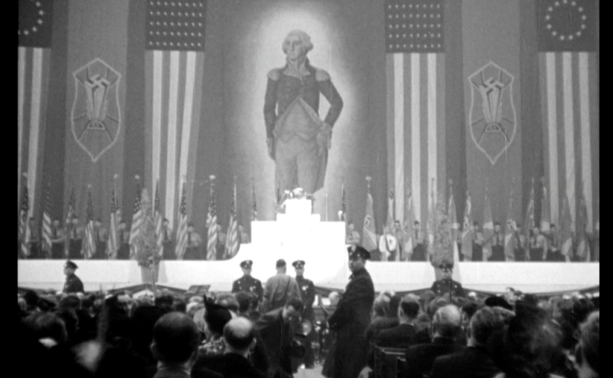 An enormous portrait of George Washington hung alongside Swastika banners and American flags at Madison Square Garden.