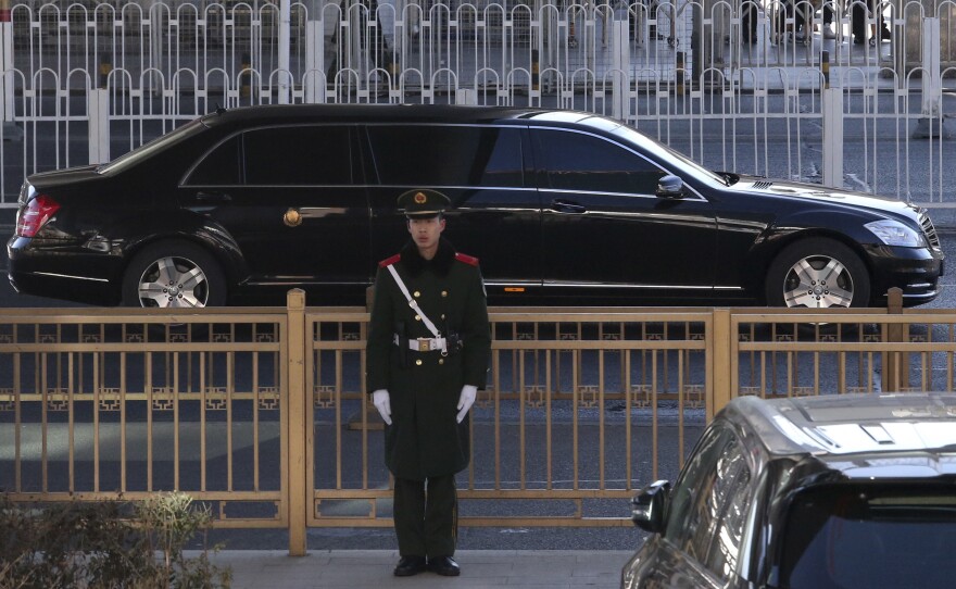 A sedan, believed to carry North Korean leader Kim Jong Un, leaves a train station with a convoy in Beijing. Kim is making a four-day trip to China in what's likely an effort by to coordinate with his only major ally ahead of a summit with U.S. President Donald Trump that could happen early this year.