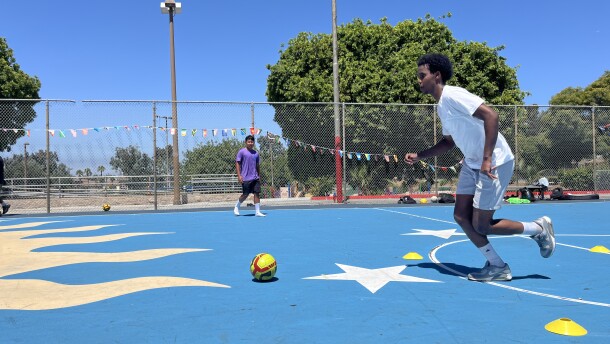 Khalid Hassan dribbles a soccer ball at Colina Del Sol Park's basketball courts, July 10, 2025.