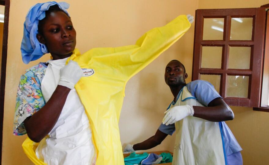 Nurse Monika Mulbah suits up before entering the Ebola ward at Firestone's clinic. Currently there are three patients, ages 4, 9 and 17.
