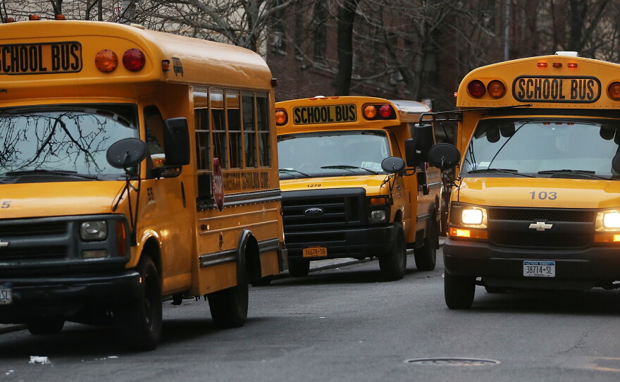 School buses idle in front of a school in Manhattan's East Village on Jan. 15, 2013.