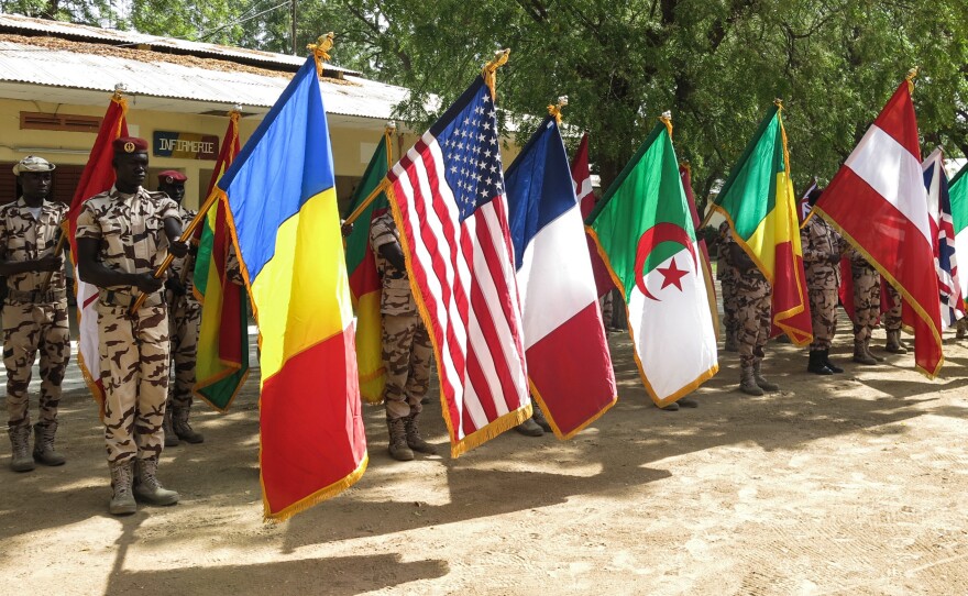 Flag-carrying Chadian soldiers on parade at the closing ceremony in Ndjamena, Chad of Flintlock 2017, US military-led counterterrorism exercises involving forces from 27 countries in 7 locations across west and north Africa.