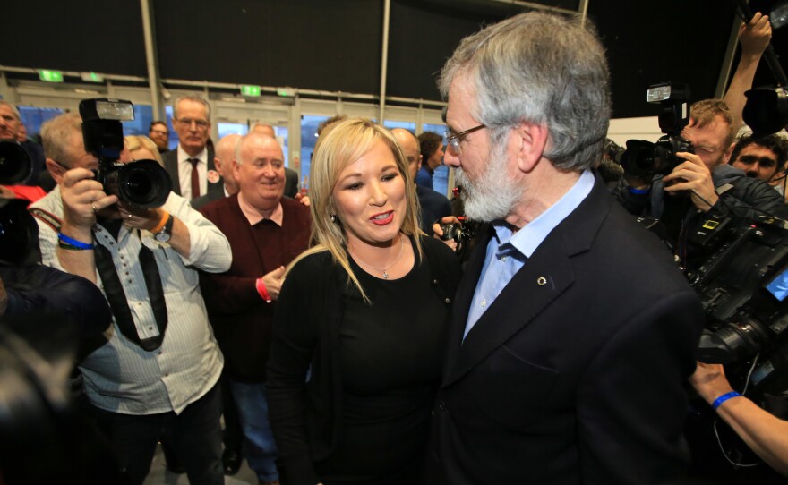 Michelle O'Neill, Sinn Fein's new leader in Northern Ireland, talks with overall party leader Gerry Adams and members of the media in Belfast, Northern Ireland, on Friday. Sinn Fein, which used to be on the U.S. terrorism watchlist for its connection to the so-called Irish Republican Army, saw massive gains in the recent election.