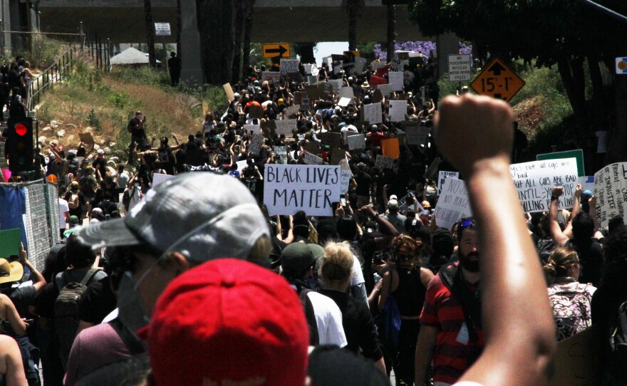A group of demonstrators march towards downtown San Diego, May 31, 2020.