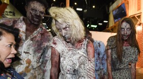 Zombies practice their walk at AMC's "Walking Dead" booth before Preview Night at Comic-Con International held at the San Diego Convention Center, July 8, 2015. 