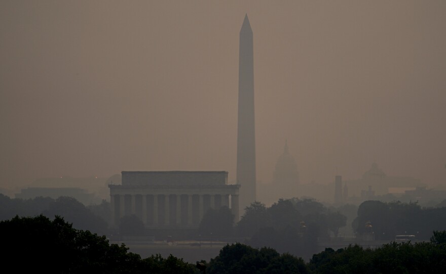 Haze blankets over monuments on the National Mall in Washington, Wednesday, as seen from Arlington, Va.