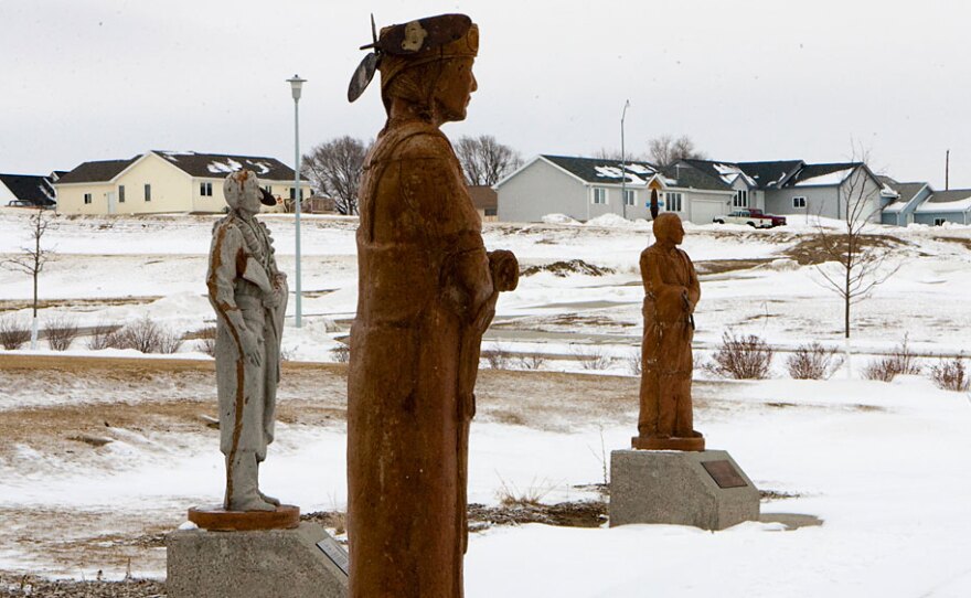 Statues depicting the various clans within the Winnebago tribe overlook a housing development north of Winnebago, Neb., which was built on land purchased by the tribe.