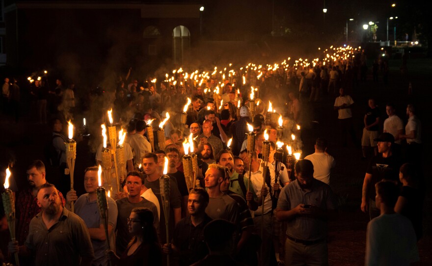 White nationalists carry torches on the eve of a Unite The Right rally in Charlottesville, Va., on Aug. 11.