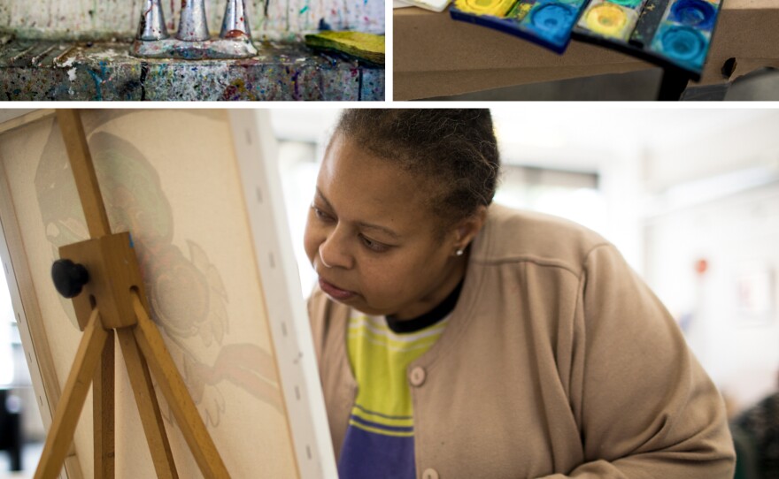 A paint-splattered sink and open watercolor palette show signs of art in progress at Art Enables, a studio for people with disabilities that was founded in 2001. Artist Vanessa Monroe, who has been interested in art since childhood, concentrates as she paints a canvas at Art Enables. "We're just like family," she says about being part of the studio.