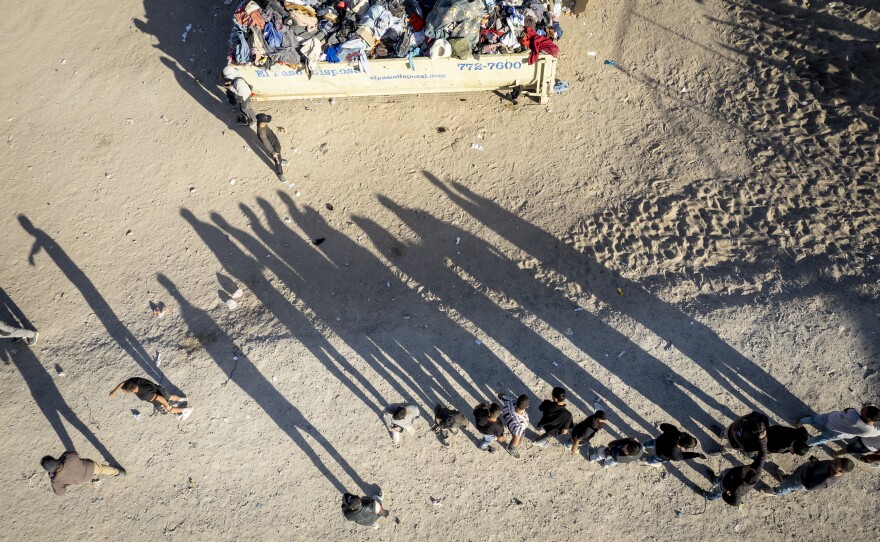 As seen from an aerial view, immigrants line up to be processed by U.S. Border Patrol agents at the U.S.-Mexico border on Friday, in El Paso, Texas.