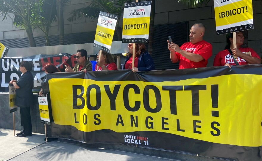 Members of Unite Here Local 11 picket in front of the JW Marriott hotel in downtown Los Angeles on August 24, 2023.