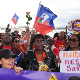 People chant during a rally in Fort Lauderdale, Fla., in support of the extension of Temporary Protected Status (TPS) for Haitian immigrants.