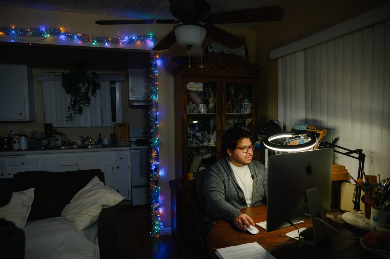 Joshua Lopez uses his computer at his home at the Hawaiian Gardens apartments in Imperial Beach, California on Nov. 18, 2024. Lopez is one of dozens of tenants facing eviction and is urging the Imperial Beach City Council to pass new local protections for renters.