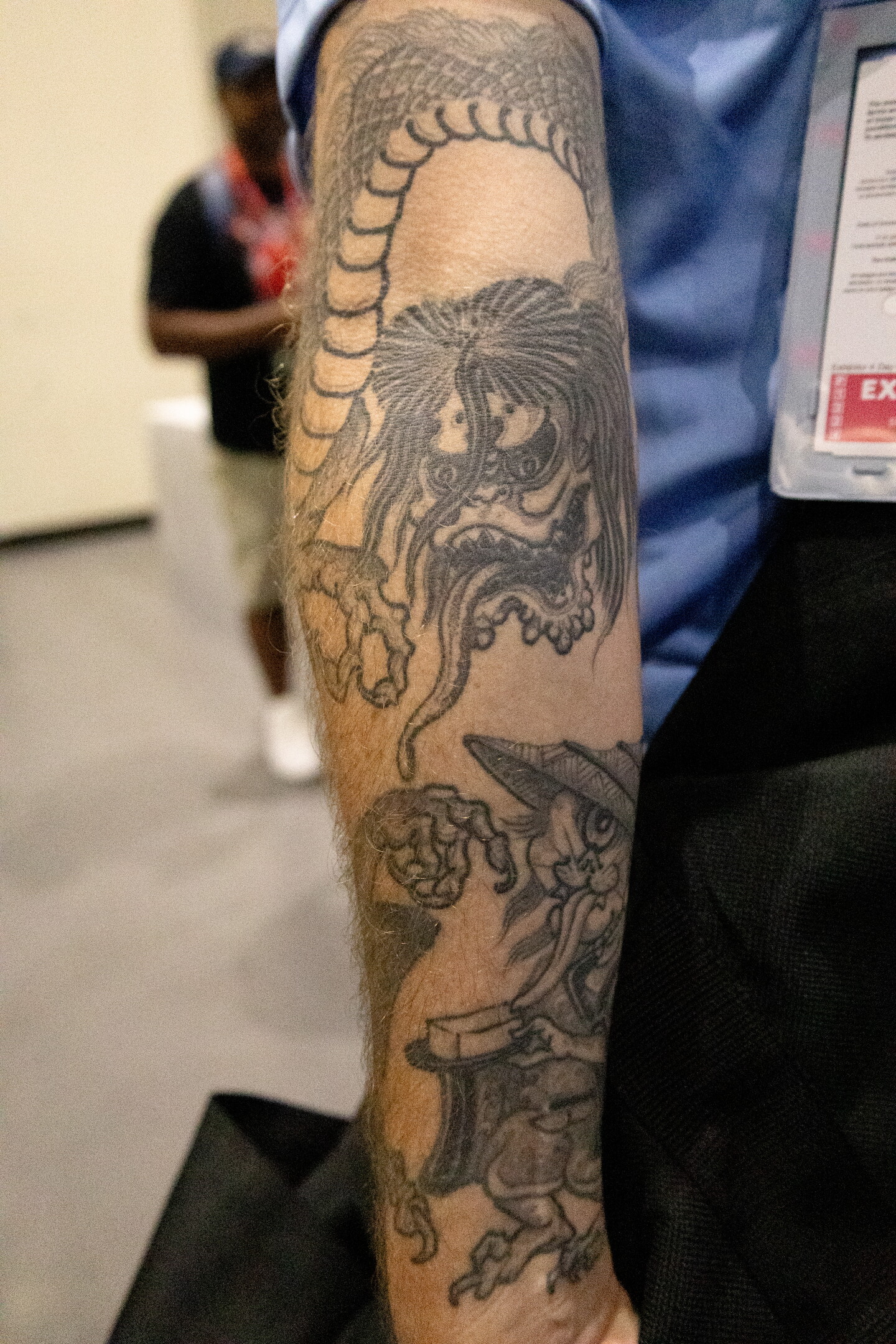 A Japanese oni-inspired tattoo snarls on the arm of an attendee at Comic-Con, July 23, 2026.