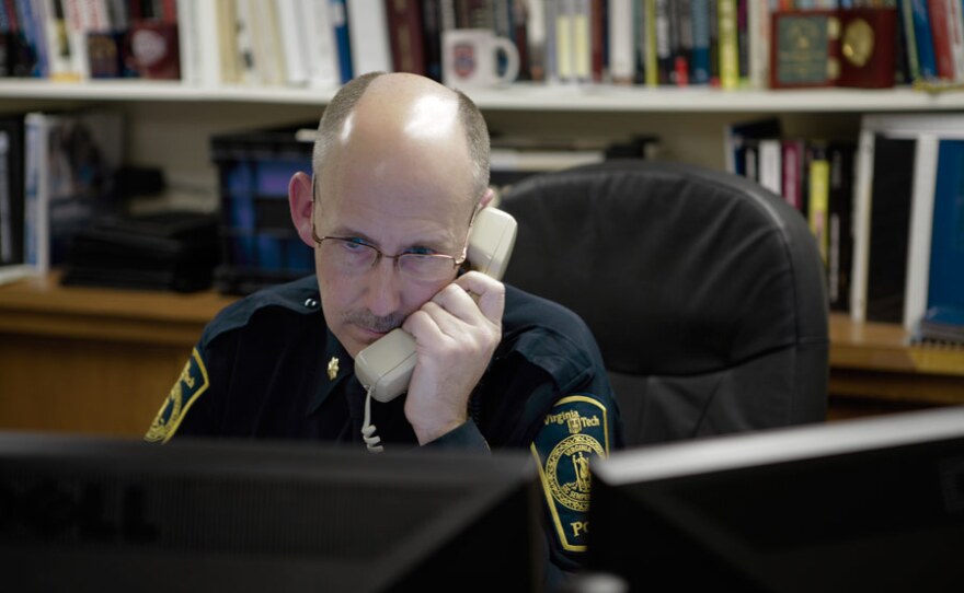 Gene Deisinger, Director of Threat Management, on the phone in his office at Virginia Tech.