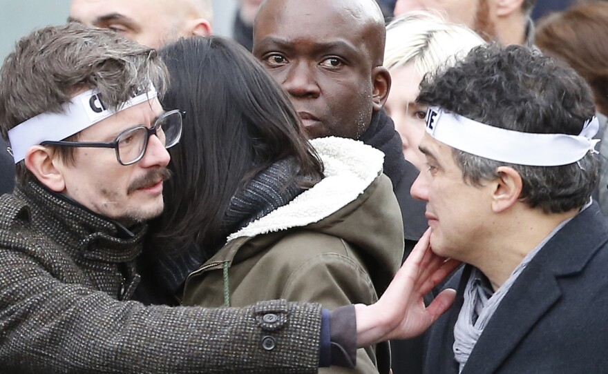 Charlie Hebdo editorialist Patrick Pelloux (right) and cartoonist Renald Luzier, known as Luz (left), join a march in Paris on Sunday.