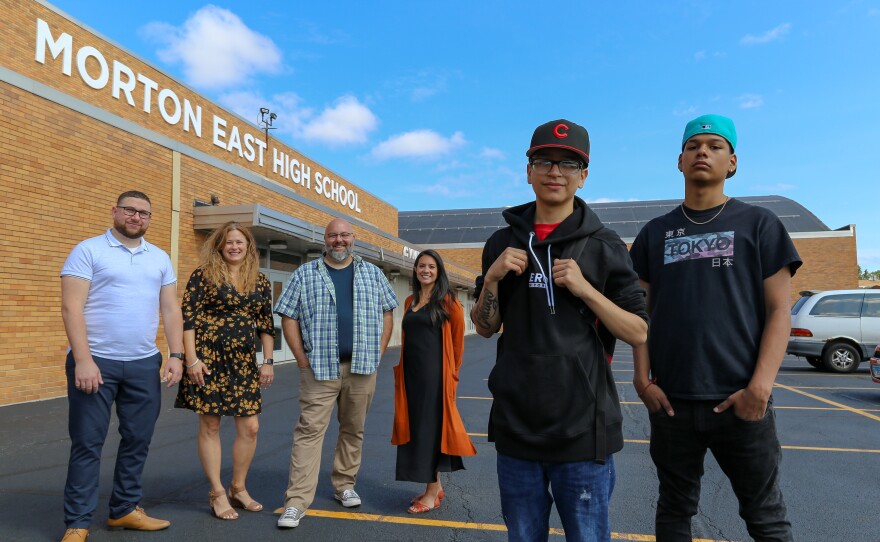 Cicero, Ill— Teachers Mark Sujak, Sarah Lorraine, Jeremy Robinson and Sophia Faridi pose with students and podcast finalists Julian Fausto and Eric Guadarrama for portraits in front of Morton East High School, Friday July 30, 2021. Photo: Olivia Obineme for NPR.