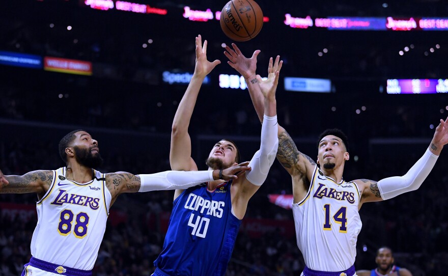 Players from the Los Angeles Clippers and Los Angeles Lakers, shown here during a game in March, will face each other on Thursday evening as the NBA season restarts.