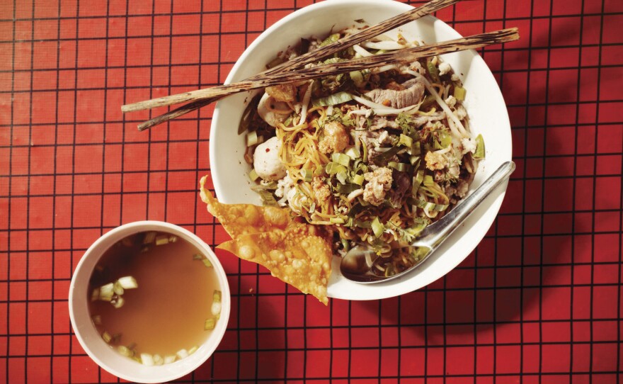 Ricker says this noodle dish translates roughly from the Thai as spicy, sweet, tart noodles with pork, peanuts and herbs.