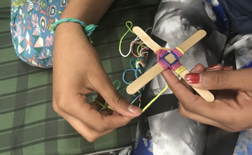 An asylum-seeking child creates artwork at a migrant shelter in San Diego, Feb. 13, 2019.