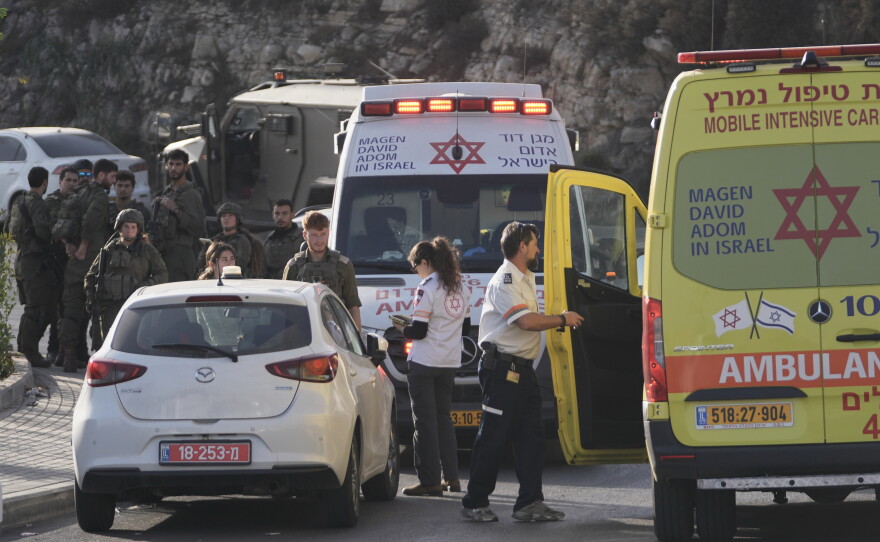 Israeli soldiers and emergency personnel gather near ambulances following a shooting attack near Yehuda Junction, near Hebron, in the occupied West Bank, Friday, Oct. 23, 2026.