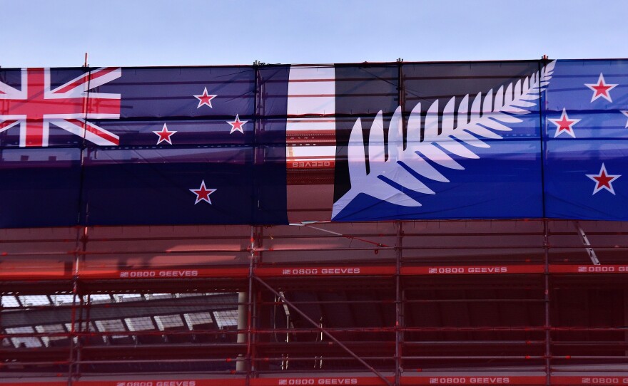 The current New Zealand flag (left) hangs next to the alternative flag on a building site in Wellington on March 4. New Zealanders began voting March 3 on whether to adopt a new flag.