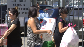 People carry in donations to the Border Angels office near downtown San Diego to be given to undocumented migrant families from Central America, July 7, 2014.
