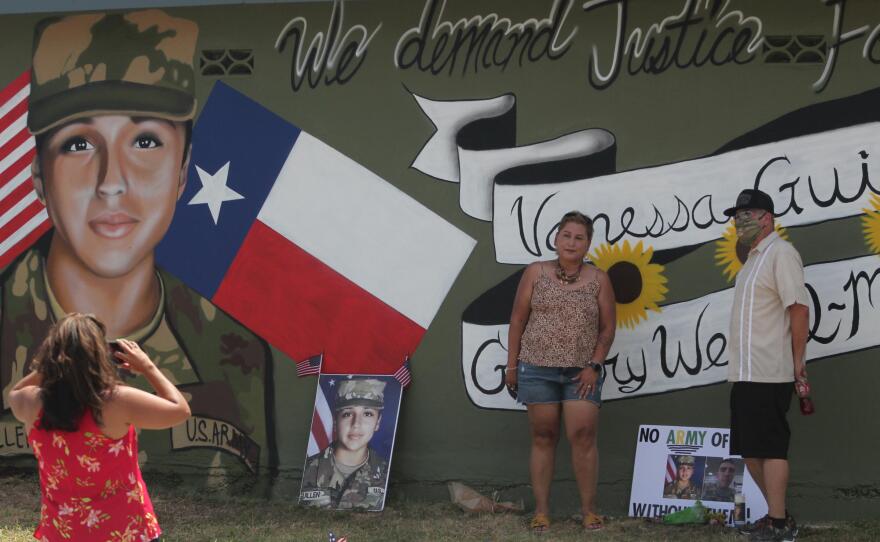 Larissa Martinez of the organization Circle of Arms takes photos at the unveiling of a San Antonio mural. It pays tribute to Vanessa Guillen and Gregory Wedel Morales, two Fort Hood soldiers who were found dead near the base in separate incidents this year.