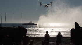 A V-22 Osprey flies during an amphibious demonstration at the 250th Marine Corps birthday event at Camp Pendleton.